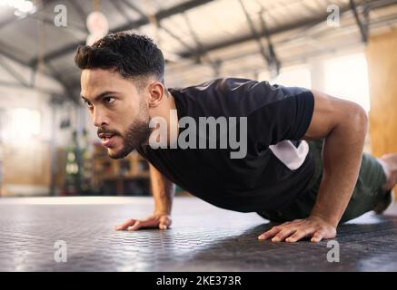 frontview of young sporty girl with athletic body doing push ups on gym  floor Stock Photo by serhiibobyk