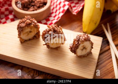 Banana sushi sweet rolls with caramel, peanut butter and chocolate puffed rice. Funny and easy homemade snack for kids and adults. Stock Photo