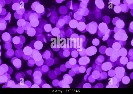 Defocused christmas lilac purple abstract bokeh lights background. Festive lights. Blurred holiday bokeh. Stock Photo