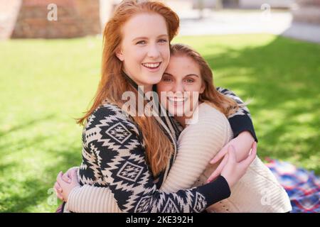 My bestie gives the best hugs ever. two happy friends hugging outdoors. Stock Photo