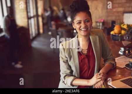 I follow the free wifi. Portrait of a young woman standing in a cafe. Stock Photo
