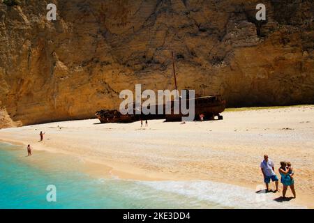 Navagio beach with a shipwreck and people on a trip on the island of Zakynthos in the Ionian Sea in Greece. Stock Photo