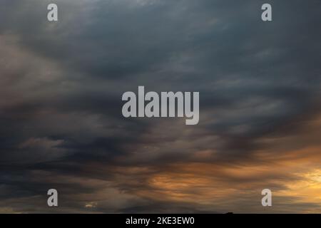Dramatic clouds at sunrise or sunset. Weather forecast concept photo. Dark clouds. Stock Photo