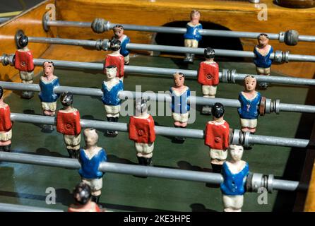 From above hand painted miniatures of different teams installed on rod of retro table football Stock Photo
