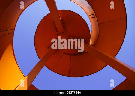 Detail of a spiral viewing platform. Abstract architecture in bright orange and blue sky background. Stock Photo