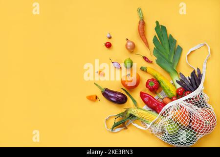 String bag with vegetables on yellow background. Copy space. Top view. High resolution product Stock Photo