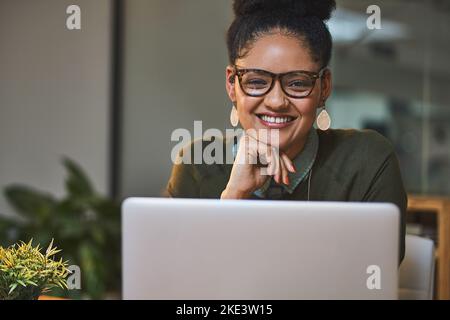 You can count on me to meet that deadline. a happy businesswoman using wireless technology in her office. Stock Photo