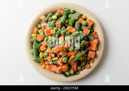 Frozen mixed vegetables on a white background Stock Photo