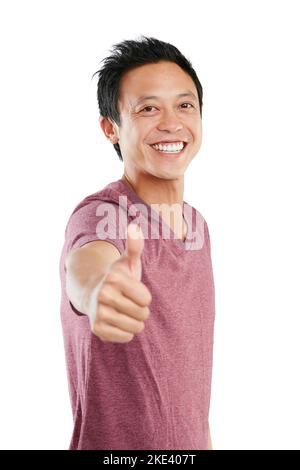 Youve got my vote. Studio portrait of a young man standing and giving a thumbs up against a white background. Stock Photo