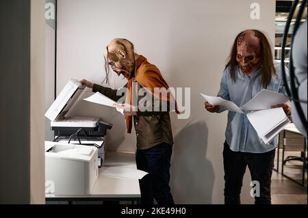 Zombies at copier in the office Stock Photo