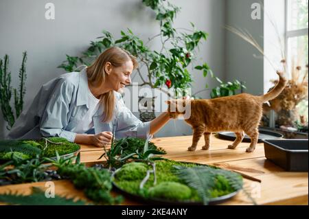 Young woman florist decorator working at workshop Stock Photo