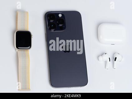 New york, USA - November 8, 2022: Apple smart devices iphone, watch and earphones lay on white background Stock Photo