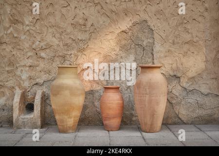 Earthen pots kept near old heritage building at Al Seef, Dubai, UAE - Stock Photo