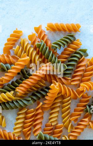 Dry tricolor fusilli pasta on wooden table Stock Photo - Alamy