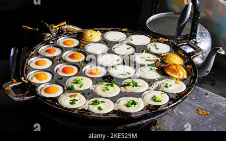Thai street food in Chiang Mai with fried eggs and coconut pudding pancakes Stock Photo