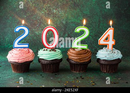 Happy New Year 2024 Festive Doodles Theme Stock Photo Alamy   Buttercream Frosted Cupcakes With Number Candles For The New Year 2024 2ke52xf 