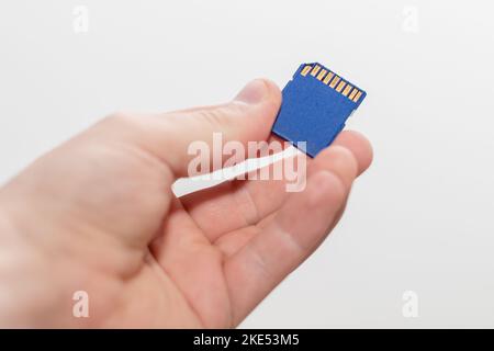 Caucasian man holding a sdhc memory card in a hand Stock Photo