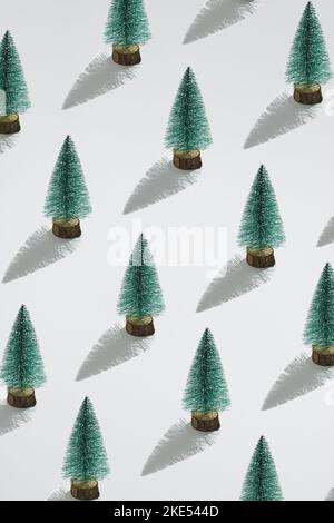 Minimal composition pattern background of green Christmas trees on white background. New Year concept. Stock Photo