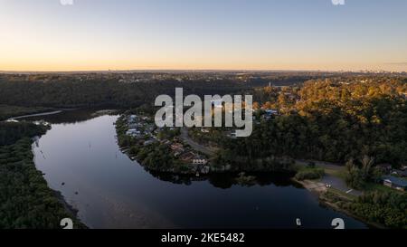 Aerial view of Woronora River surrounded by lush greenery at sunset in Sydney, New South Wales, Australia Stock Photo