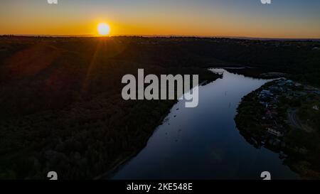 Aerial view of Woronora River surrounded by lush greenery at sunset in Sydney, New South Wales, Australia Stock Photo