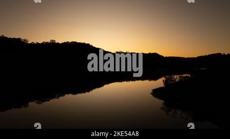 Aerial view of Woronora River surrounded by lush greenery at sunset in Sydney, New South Wales, Australia Stock Photo