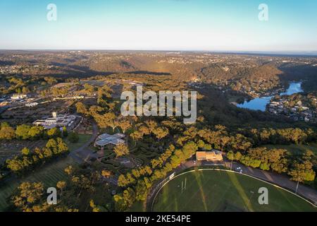 Aerial view of sporting ground, Sutherland Oval, Woronora River and Sutherland suburb surrounded by lush greenery, Sydney, NSW, Australia Stock Photo