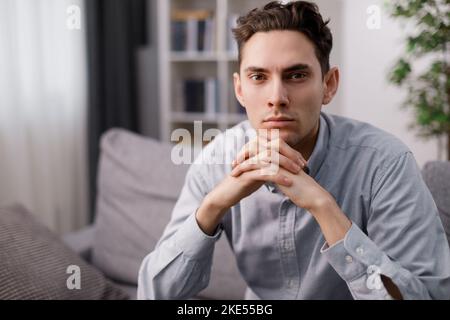 Confident man on couch Stock Photo