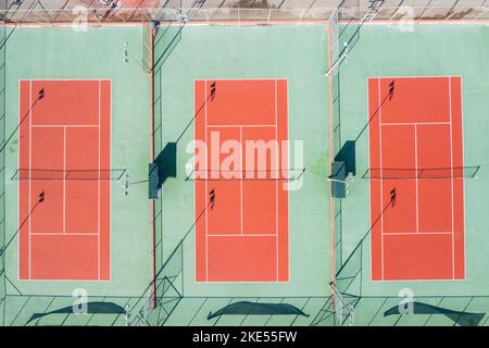 An aerial top view of tennis courts on a sunny day Stock Photo