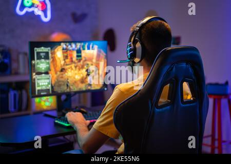 Professional Gamer Playing Online Video Game on Computer with Colorful Neon Led Lights. Stock Photo