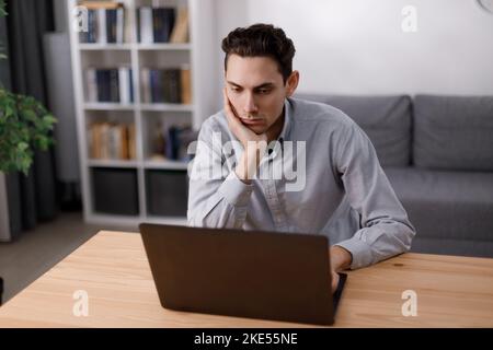 Focused man using laptop Stock Photo