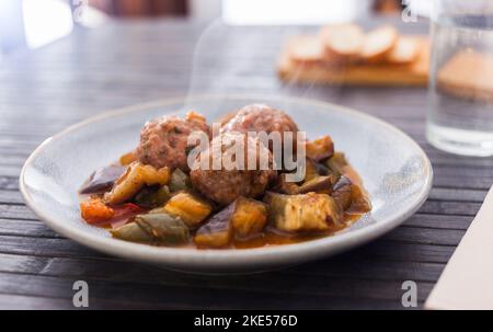cooked meatballs with stewed eggplant with haze in bowl Stock Photo