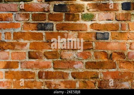 Abstract background wall of old crumbling red brick. Stock Photo