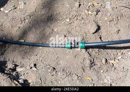 Drip irrigation ball valve. New drip irrigation system in a park before planting plants, ball valve close-up, selective focus Stock Photo