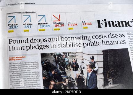 'Pound drops and borrowing costs rise as Hunt pledges to stabilise public finances' Guardian Financial newspaper headline 22 October 2022 London UK Stock Photo