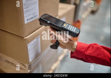 Warehouse employee scanning packaging information using a scanner Stock Photo