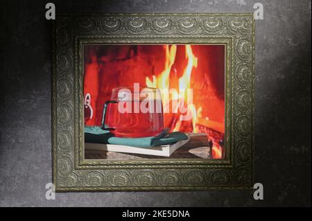 Cozy Scene Near Fireplace With Cup Of Hot Tea and Book Inside of Classic Frame Stock Photo
