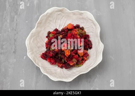 Beetroot and boiled vegetables, traditional Russian homemade salad in white bowl. Stock Photo