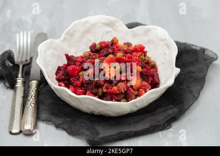 Beetroot and boiled vegetables, traditional Russian homemade salad in white bowl. Stock Photo