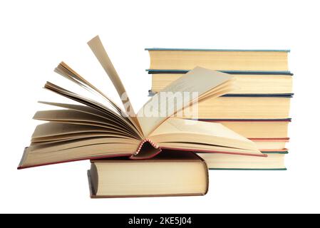 Several hardcover books in a stack and one opened isolated on a white background. Copy space. Stock Photo