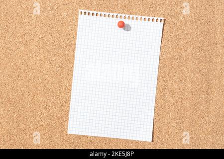 Blank grid paper sheet pinned on cork board. Template Mock up Stock Photo