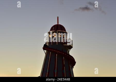 Helter skelter at the fun fair against a night sky, Goodwood Revival, Goodwood Motor Circuit, Chichester, West Sussex, England, September 2022. Stock Photo