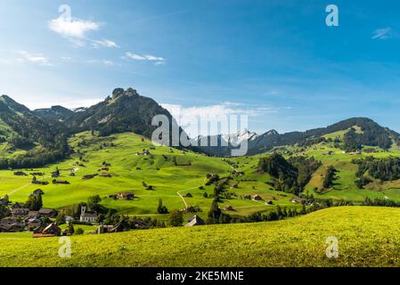 Landscape in the Toggenburg Valley with green meadows, pastures and scattered farmhouses near Nesslau, Canton St. Gallen, Switzerland Stock Photo