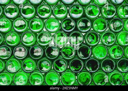 Glass bottles green. Green glass bottles of beer. Wall formed by green bottles. Green bottles background. Empty Glass Bottle with Lighting Stock Photo