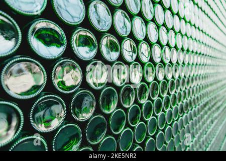 Glass bottles green. Green glass bottles of beer. Wall formed by green bottles. Green bottles background. Empty Glass Bottle with Lighting Stock Photo