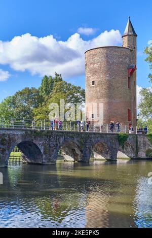 Bruges, Belgium - September 7, 2018: Tourists on the viaduct over the Minnewatwr canal with the Powder Tower in the background Stock Photo