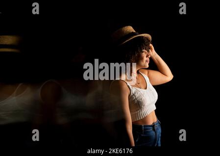 Time-lapse view of woman moving a hat. Long exposure, motion blur. Happy woman Stock Photo