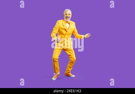 Funny mature man in suit dancing Stock Photo