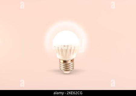 Luminous LED lamp on a light background. Energy saving technology. Stock Photo