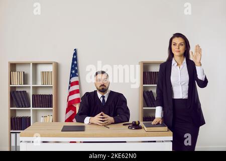 Male judge in court with witness make oath Stock Photo