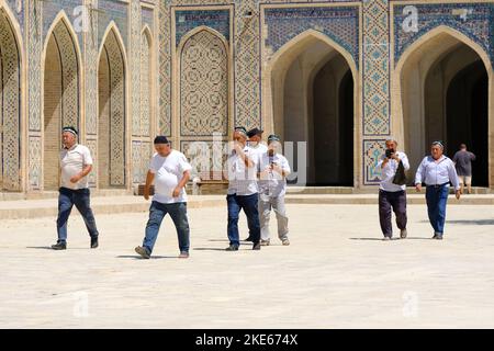 Bukhara Uzbekistan - Local Uzbeki men arrive to pray at the Kalyon Mosque ( also known as the Juma Mosque ) in August 2022 Stock Photo